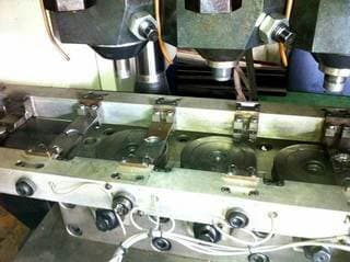 Automatic workpiece transfer system with servo drive alternately moves the workpiece to the forging positions