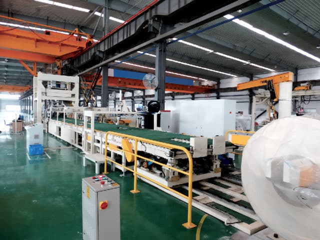 automatic horizontal steel coil packaging line in a factory workshop